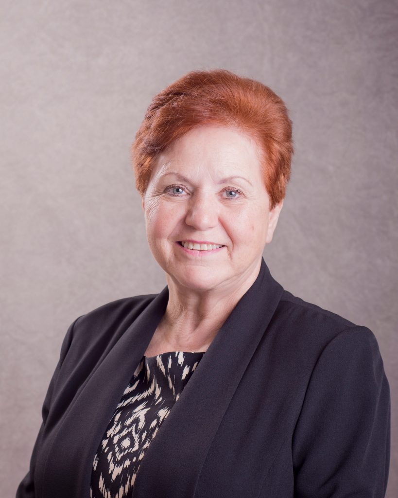 Female Coldwell Banker business professional headshot portrait on gray background in Clarksville, TN Older