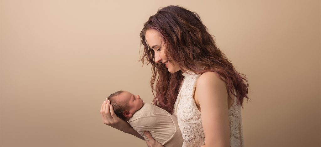 Mom holding baby newborn session love at first site