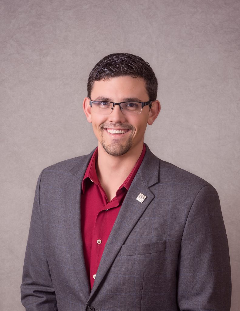 Red shirt with gray jacket. Man in suit with gray background for headshot portrait session in Clarksville, TN