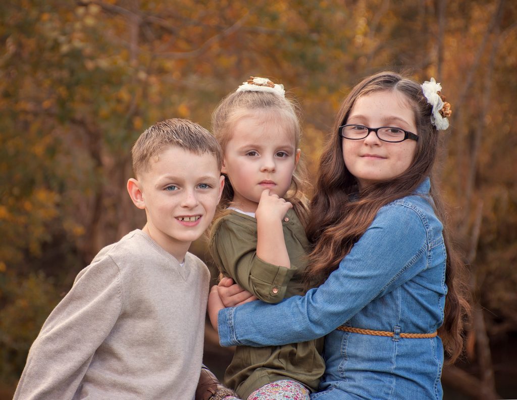 Clarksville Family Photographer with 3 kids in the fall with sweaters