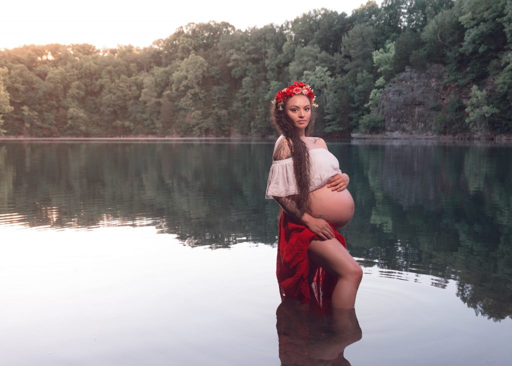 Mexican-themed Cultural Tribal Maternity dress shoot in Clarksville Tennessee TN red dress in the woods trees in the water at sunset