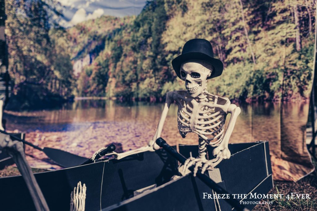 Mr Bones family Clarksville Tennessee spooky scary skeletons halloween decor decoration outside skeleton riding a boat with a black top hat