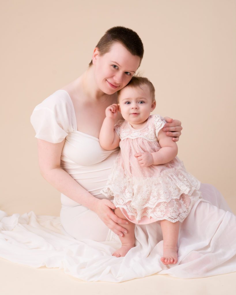 Maternity session in white dress and daughter