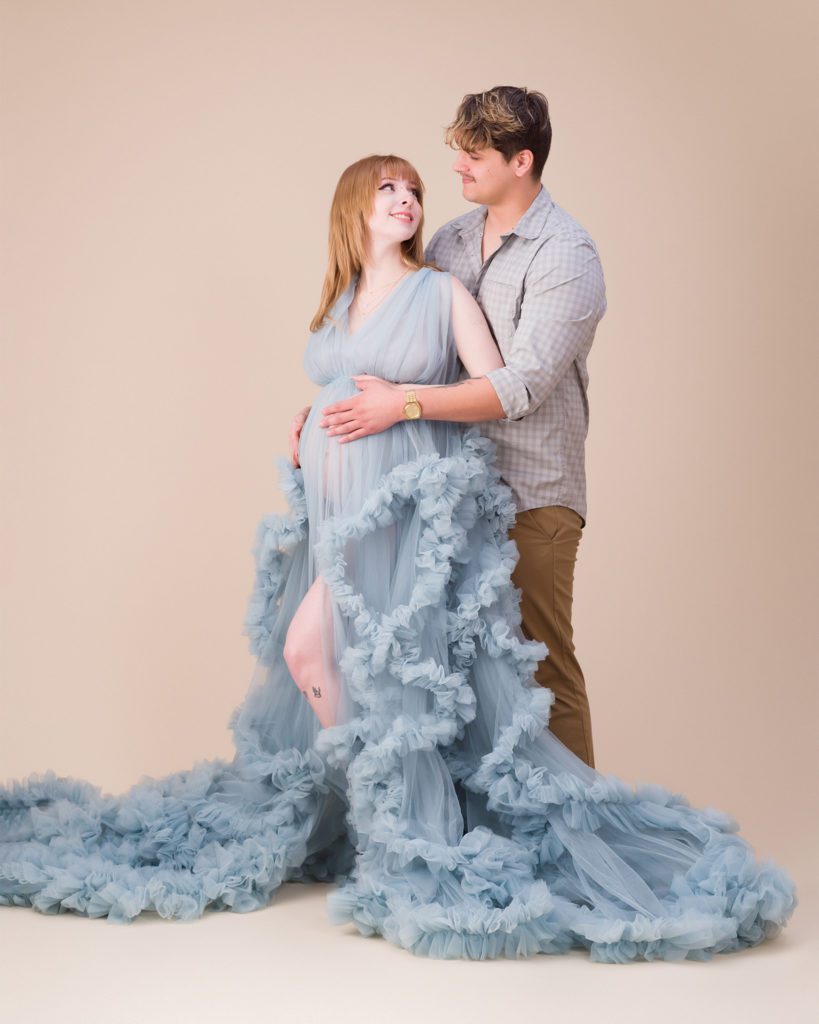 Studio maternity session with husband in a blue dress