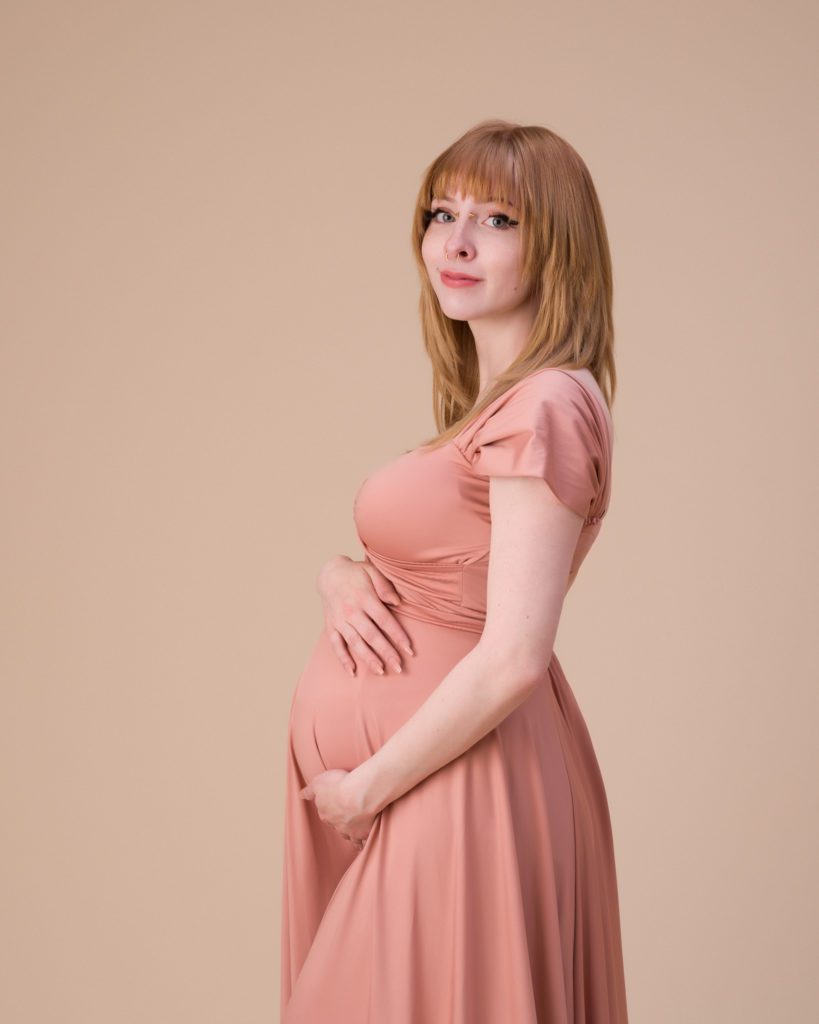 Studio maternity session with pink maternity dress