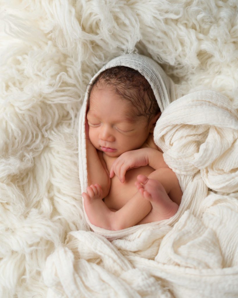 Newborn baby boy wrapped up sleeping